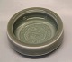 Royal Copenhagen Art Pottery 21933 RC Round tray, 3,7 x 11.5 cm, Celadon glaze 
with bird Jorgen Mogensen 

